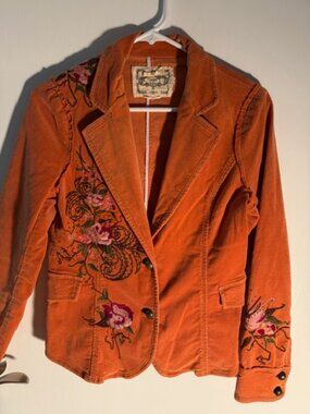 Corduroy jacker with embroidery and ruffle details.